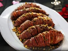 a white plate topped with meat covered in sauce