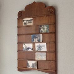 a wooden wall hanging with pictures on it's sides and some magnets attached to the side