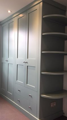 an empty room with some shelves and cupboards