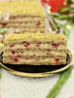 a piece of cake sitting on top of a black plate next to a christmas tree