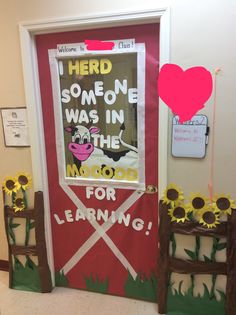 a classroom door decorated with sunflowers and an i heart sign