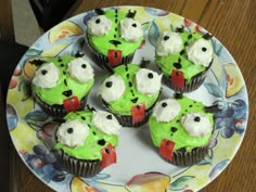 cupcakes with green frosting and white icing on a plate