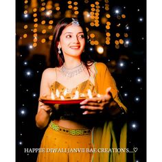 a woman holding a cake with lit candles on it