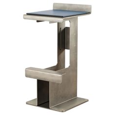 a metal table with a blue top sitting on it's side, in front of a white background