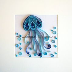 a paper sculpture of a blue jellyfish with bubbles on it's back side