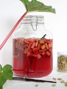 a glass jar filled with liquid and vegetables