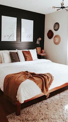 a large bed sitting in a bedroom on top of a wooden floor next to a window