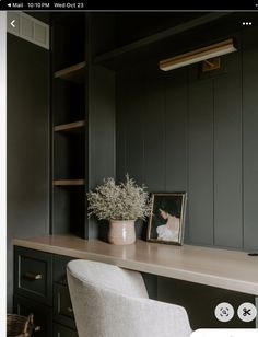 a white chair sitting in front of a desk with a potted plant on it