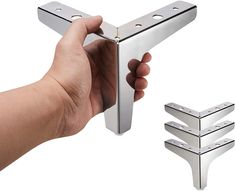 a hand holding a metal door handle with three pieces of it in the foreground