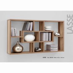 a wooden shelf filled with books and vases