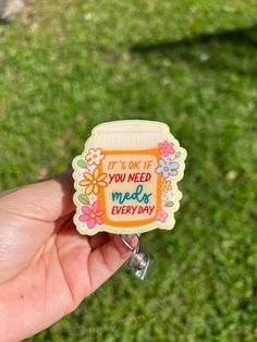 a hand holding a small jar with the words it's ok if you need meds every day