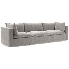 a gray couch sitting on top of a white floor