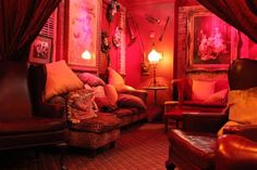 a living room filled with furniture and red lighting