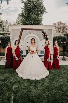 a bride and her bridal party in red dresses