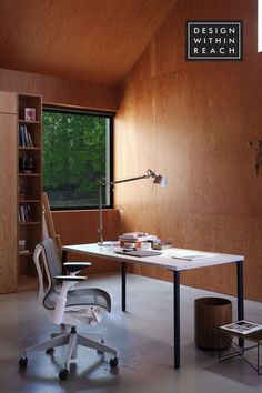 an office with a desk, chair and bookshelf