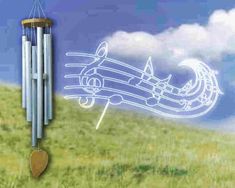 a wind chime in the grass with music notes coming out of it