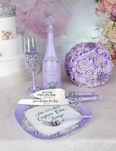 a table topped with purple flowers and wine glasses