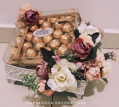 chocolates and flowers in a basket on a table