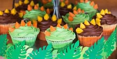 cupcakes with green frosting and orange decorations