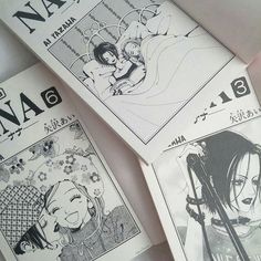 three anime book pages laying next to each other on top of a white tablecloth