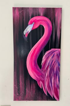 a painting of a pink flamingo on a black and purple background is hanging on the wall