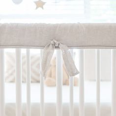 a white crib with a bow on it