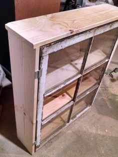 an old cabinet with glass doors is being made into a bookcase in the process of being built