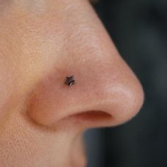 a close up of a person's nose and nose with small black stars on it