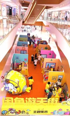 the inside of a store with people walking around it and lots of toys on display