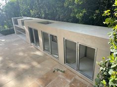 an outdoor room with glass doors on the outside