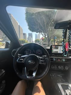 the interior of a car with steering wheel, dashboard and display screen showing various items