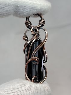 This listing is for an oxidized copper pendant created by me, in my 'Tyet' style.  The crystal is a beautiful and gemmy Black Tourmaline. This crystal is in it's raw, natural state.  Dimensions: 45mm x 13mm x 11mm Weight: 8 grams This pendant comes ready to wear with a free chain and polishing cloth.  The photos are of the item you will receive. Please note the size of the item featuring a US Quarter for reference. Thanks for looking!