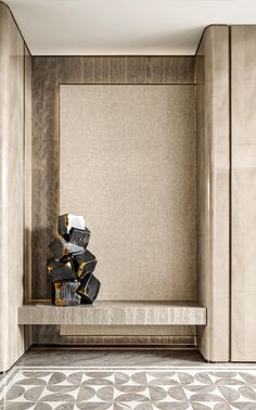 an empty room with gold and black decorations on the shelf in front of the mirror