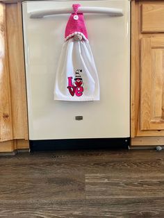 a white dishwasher sitting inside of a kitchen