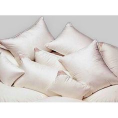 four white pillows stacked on top of each other