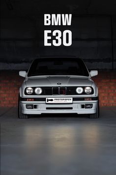 a bmw e38 parked in a garage with the words bmw e36 above it