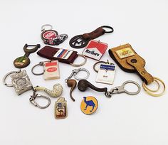 a collection of keychains and other items on a white surface with clippings