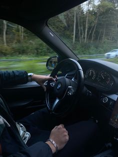 a man driving a car while holding a tablet