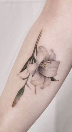 a white flower tattoo on the arm