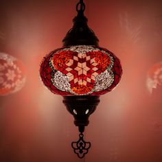 a red and white light hanging from a ceiling