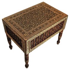 an ornately decorated table with wooden legs