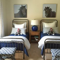 two twin beds in a bedroom with blue and white bedding