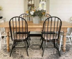 a wooden table with four chairs around it