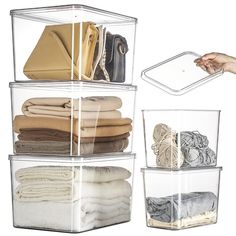 three clear storage containers filled with folded clothes and hand reaching for the lid on each container