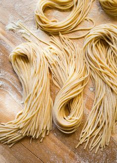 some uncooked pasta sitting on top of a wooden table