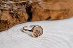 This ring features a beautiful warm earthy colored dendritic agate with plant like inclusions.   The ring is simple yet bold and also sturdy so you can wear it every day.  I chose a 14k gold bezel as it compliments the earthy color of this dendrite. I finished the ring in a mirror shine. Details: - this ring measures a US size 8.25 (18.25 mm), Due to the wide band it will best fit a US size to 8 (18 mm).  - the face of the ring measures about 15 mm (0.6 inch) x 13 mm (0.5 inch) - the ring band is about 4 mm wide and 2 mm thick - the material used is recycled sterling silver and recycled 14k solid gold The plant like inclusions, called dendrites, are made from traces of iron oxide and/or manganese and grow in the rock as it forms. Each stone is totally unique. Dendrite agates, with their sm Minimalist Sterling Silver Rings With Natural Inclusions, Nature-inspired Agate Rings With Natural Inclusions, Nature-inspired Sterling Silver Cabochon Ring, Earthy Rings, Obsidian Ring, Dendritic Agate, La Face, Agate Ring, Silver Moon