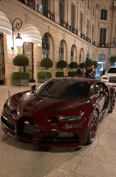 a bugatti is parked on the street in front of a building