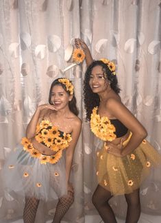 two women dressed in sunflower costumes posing for the camera