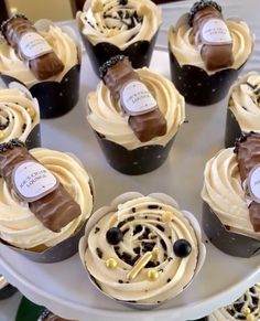 several cupcakes with frosting and chocolate decorations