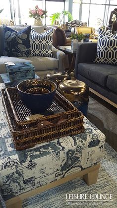 a living room filled with lots of furniture and pillows on top of a rug covered floor